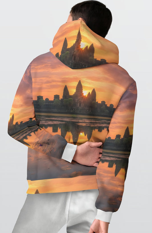 Person wearing a hoodie with a sunset over a cityscape design on the back.