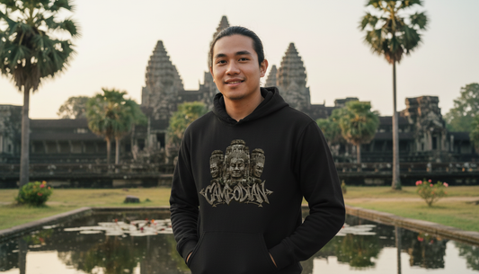 Person wearing a black hoodie with a logo in front of Angkor Wat.