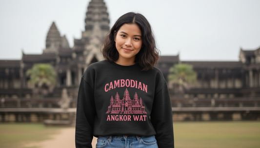 Woman wearing a black sweatshirt with 'Cambodian Angkor Wat' text in front of Angkor Wat.
