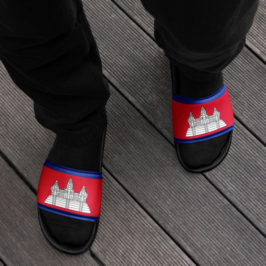 Black slippers with red and blue bands featuring a temple design on a wooden floor.