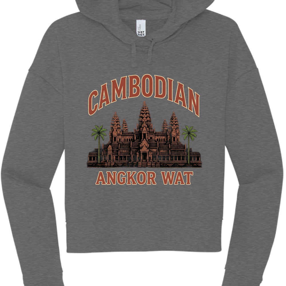The artwork is a multi-colored illustration celebrating Cambodian heritage:

Typography: The word "CAMBODIAN" is arched at the top, and "ANGKOR WAT" is printed straight across the bottom. Both are in a bold, blocky font with a terracotta-orange fill and a light cream or tan outline.

The Temple: A central illustration of the Angkor Wat temple complex is rendered in earthy brown and reddish-orange tones, highlighting its iconic tiered spires.

Landscaping: Two vibrant green palm trees flank the temple, addin
