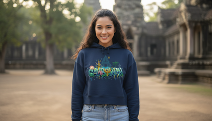Woman wearing a hoodie with a colorful design in front of an ancient temple.
