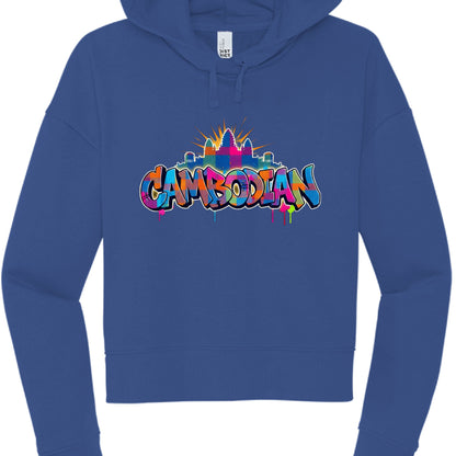 The central graphic is a multi-layered illustration that blends street art aesthetics with Cambodian heritage:

Typography: The word "CAMBODIAN" is written in a bold, bubble-style graffiti font. The letters feature a colorful "patchwork" or checkered fill using shades of pink, orange, blue, green, and yellow.

Iconography: Directly above the text is a stylized silhouette of Angkor Wat, the iconic temple complex. It uses the same multi-colored patchwork motif and is accented by a golden-yellow sunburst radia