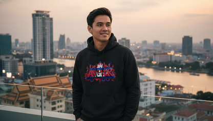 Man wearing a black hoodie with colorful text, standing on a rooftop with a cityscape in the background.