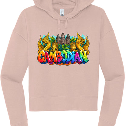 The final image features a dusty rose cropped hoodie with a vibrant graphic that integrates traditional Khmer symbolism into a modern, graffiti-inspired layout. This design shares the bold, "pop-art" aesthetic seen in previous iterations but uses a symmetrical arrangement.

Graphic Composition
Central Imagery: The background of the graphic features the iconic towers of Angkor Wat, flanked by two traditional Apsara figures with golden crowns.

Guardian Figures: Framing the entire upper half of the design are