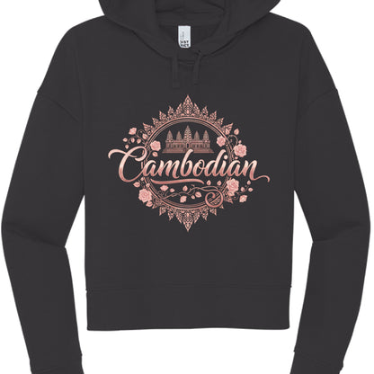 Black "Rose Gold" Hoodie
This version offers a sleek, minimalist, and elegant look.

Typography: The word "Cambodian" is written in a graceful, rose gold-toned cursive script.

Central Emblem: A simplified silhouette of Angkor Wat is placed at the top center of a circular frame.

Framing: The entire graphic is contained within an ornate, rose-gold circular border featuring delicate floral vines and pink rose blossoms.
