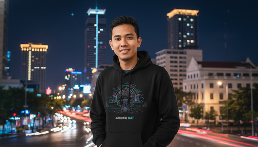 Man wearing a black hoodie with a cityscape in the background
