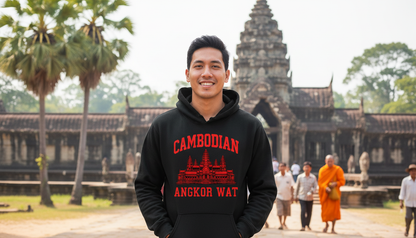Person wearing a black hoodie with red text and graphics in front of Angkor Wat.