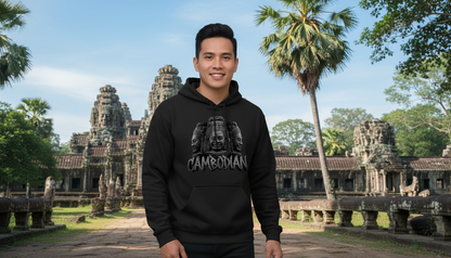 Person wearing a black hoodie with a graphic design in front of Angkor Wat temple complex.