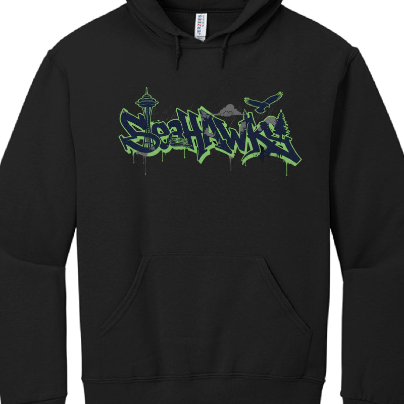 These hoodies celebrate the Seattle Seahawks with designs incorporating team colors (navy, green, and grey) and iconic Seattle landmarks.

Northwest Coast Style (image_a4521c.jpg): A black hoodie featuring a central osprey (seahawk) rendered in a traditional indigenous art style. The Seattle Space Needle is centered behind the bird's wings, and the word "SEAHAWKS" is prominently displayed in a bold green and blue font.

Graffiti Skyline Style: These designs feature "SEAHAWKS" in a stylized, neon-outlined gr