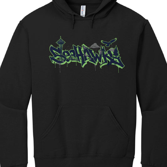 These hoodies celebrate the Seattle Seahawks with designs incorporating team colors (navy, green, and grey) and iconic Seattle landmarks.

Northwest Coast Style (image_a4521c.jpg): A black hoodie featuring a central osprey (seahawk) rendered in a traditional indigenous art style. The Seattle Space Needle is centered behind the bird's wings, and the word "SEAHAWKS" is prominently displayed in a bold green and blue font.

Graffiti Skyline Style: These designs feature "SEAHAWKS" in a stylized, neon-outlined gr
