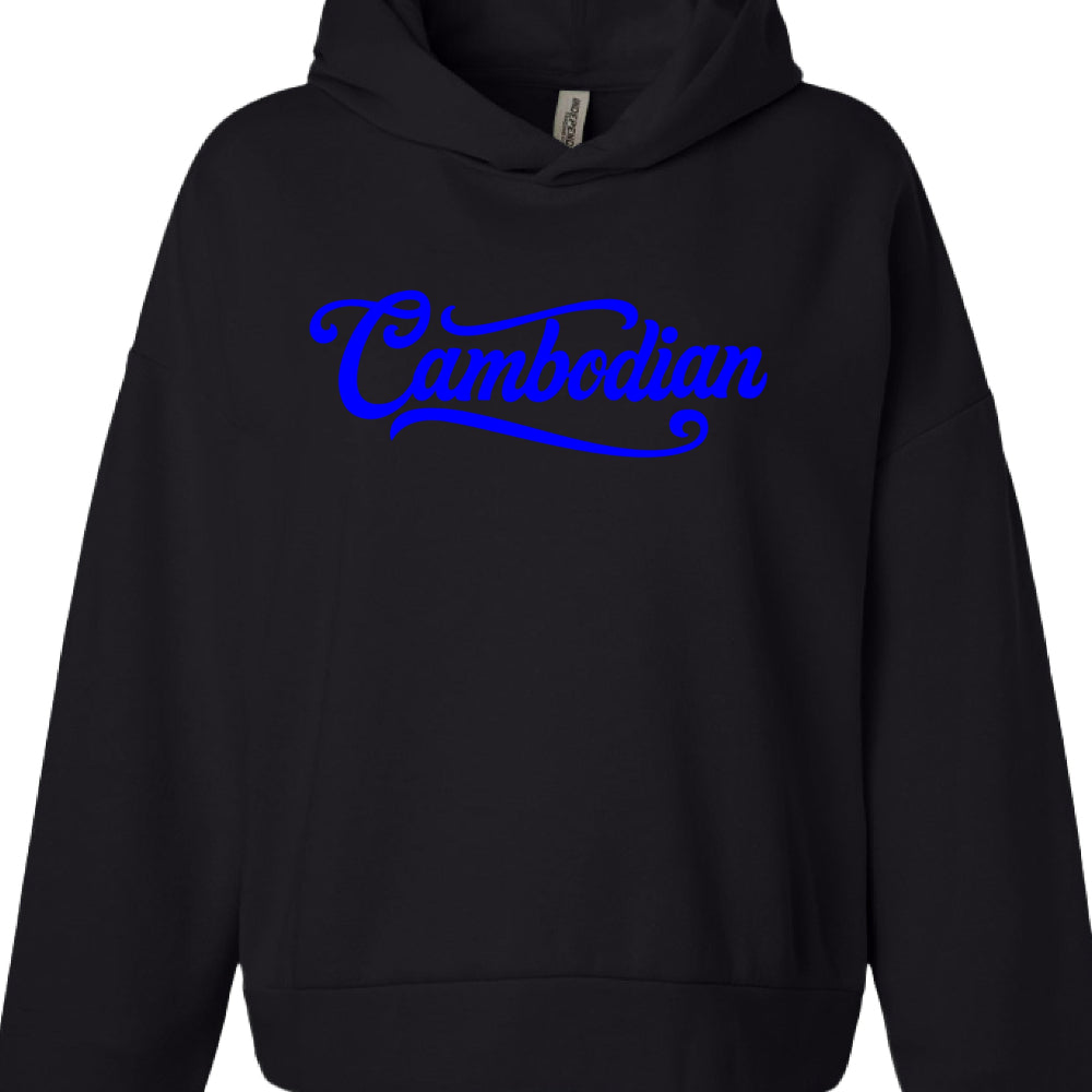 Text: The word "Cambodian" is printed across the center of the chest.

Font: A stylized, cursive script with thick strokes and decorative flourishes, similar to a retro baseball or "varsity" logotype.

Color: A vibrant, electric blue.

Detail: A thick blue underline (swoosh) extends from the final "n" back toward the beginning of the word, characteristic of classic sports apparel designs.