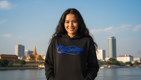 Person wearing a black hoodie with 'Cambodian' text, standing in front of a city skyline.