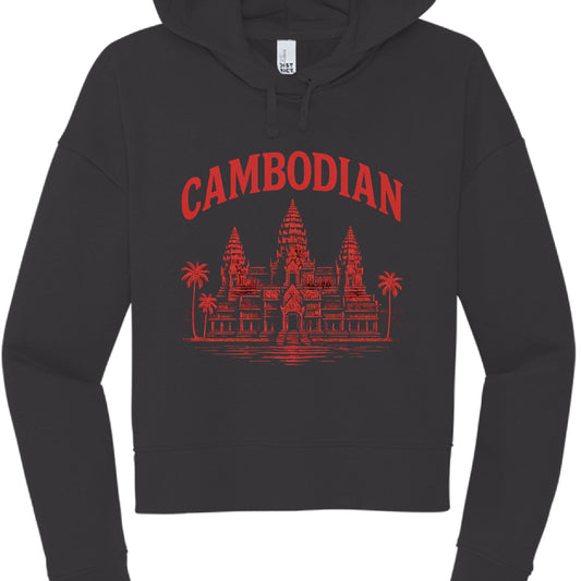 This image features a black cropped hoodie with a graphic design centered on the chest. The aesthetic blends streetwear style with cultural iconography.

Design Details
Text: The word "CAMBODIAN" is printed in a bold, red, serif font, arched across the top of the graphic.

Illustration: Below the text is a detailed red illustration of Angkor Wat, the famous temple complex in Cambodia. The artwork includes:

The iconic three-tower silhouette.

Palm trees flanking the sides of the temple.

A reflection or wat