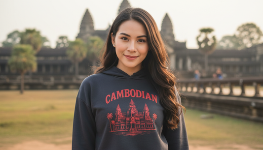 Woman wearing a hoodie with 'Cambodian' text and Angkor Wat design, standing in front of Angkor Wat temple.