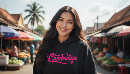 Woman wearing a black hoodie with 'Cambodian' text in pink at an outdoor market.