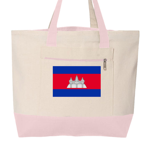 This image features a large, cream-colored canvas tote bag with soft pink accents. The design is practical and highlights a specific national symbol.

Key Features
Design & Color: The main body is a natural off-white/cream canvas. The base and the carrying handles are a pale pink.

Front Pocket: There is a large rectangular pocket on the front, secured with a horizontal silver zipper.

Central Graphic: Printed directly on the front pocket is the national flag of Cambodia, featuring its characteristic blue b