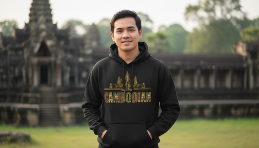 Person wearing a black hoodie with 'Cambodian' text in front of temple ruins