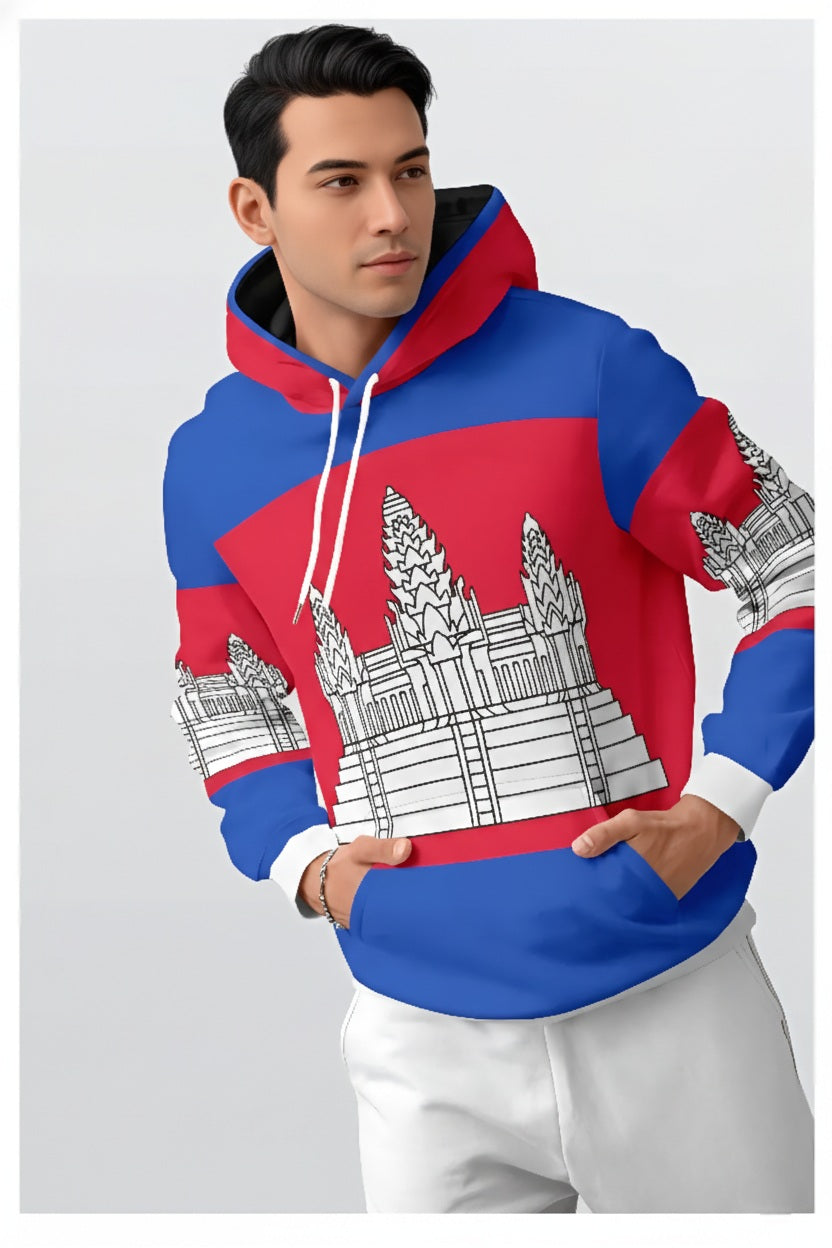 This image features a man modeling a bold, streetwear-style hoodie that incorporates the national symbols of Cambodia.

Design & Apparel Details
National Iconography: The hoodie prominently displays the Cambodian flag's color scheme of blue and red. The center of the chest and the sleeves feature a large, stylized graphic of Angkor Wat, the iconic temple complex that serves as a central symbol of Khmer heritage.

Style: It is a modern, drawstring pullover hoodie with a vibrant all-over print, consistent wit