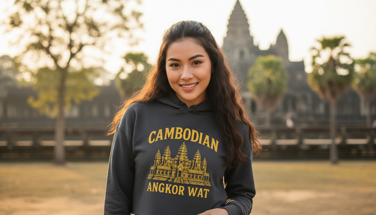 Woman wearing a hoodie with Angkor Wat design in front of Angkor Wat temple.