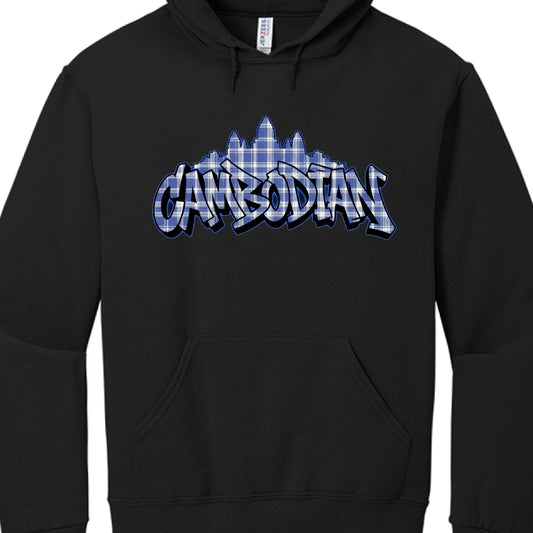 Garment: A standard black pullover hoodie with a front kangaroo pocket and drawstrings at the neck. A "Jerzees" brand tag is visible inside the collar.

Central Graphic: The word "CAMBODIAN" is rendered in a stylized, bold graffiti or "bubble letter" font.

Pattern & Color: The text and the silhouette behind it are filled with a blue and white plaid (checkerboard) pattern, reminiscent of a traditional krama (a sturdy Cambodian scarf).

Iconography: Directly behind the text is the silhouette of Angkor Wat, t