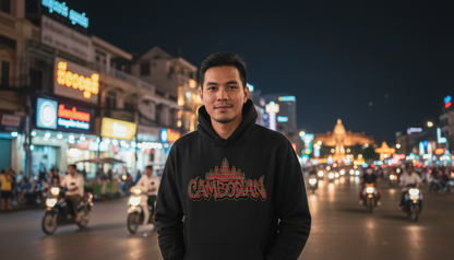 Man wearing a black hoodie with 'Cambodian' design on a busy street at night.