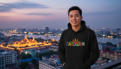 Person wearing a hoodie with 'Cambodian' text, standing in front of a cityscape at dusk.