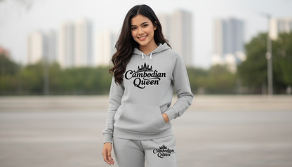 Woman wearing a gray hoodie with 'Cambodian Queen' text, standing in an urban setting.