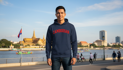 Person wearing a hoodie with 'Cambodian' text, standing in front of a cityscape with a river and buildings.