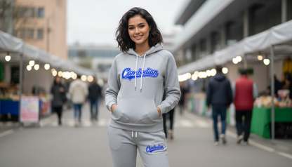 Woman wearing a gray hoodie and pants with 'Calvin Klein' branding, standing outdoors at an event.