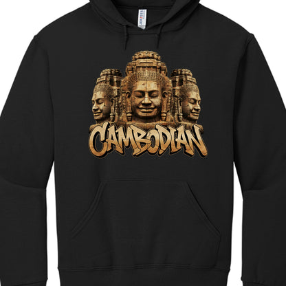 The Imagery: The central focus is a detailed illustration of three giant stone faces carved into a temple structure. These are iconic representations of the Bayon Temple at Angkor Thom, known for its "serene" or "smiling" stone faces.

The Text: Below the temple imagery, the word "CAMBODIAN" is written in a bold, stylized graffiti-like font. The letters have a textured, stone-like appearance to match the carvings above and are outlined in black and gold for a 3D effect.

Color Palette: The graphic uses eart