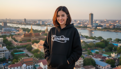 Person wearing a black hoodie with 'Cambodian' text, standing in front of a cityscape with a river and temples.