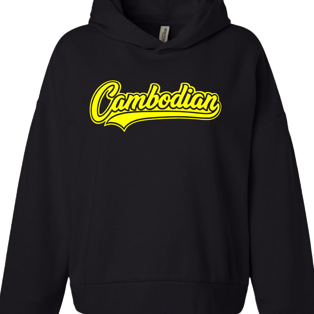 Apparel Style: A black pullover hoodie with a standard hood and a front pocket.

Main Graphic: The word "Cambodian" is printed across the chest in a stylized, cursive script font.

Color Profile: The lettering is a vibrant yellow with a thin, matching yellow outline that creates a layered effect.

Design Element: A yellow "swoosh" or tail accent extends from the bottom of the first letter, giving the design a vintage varsity or athletic team vibe.

Internal Label: A white garment tag is visible at the inner