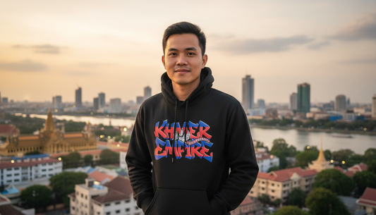 Person wearing a hoodie with 'Khmer Empire' text, standing in front of a cityscape.