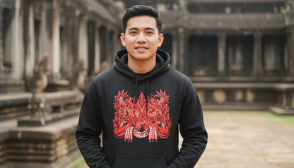 Person wearing a black hoodie with red graphics in front of ancient architecture