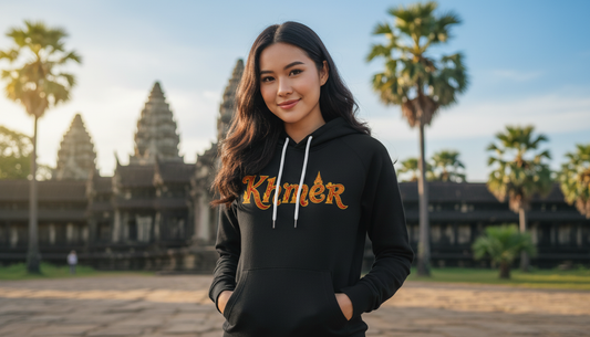 Woman wearing a black hoodie with 'Klimt' logo in front of Angkor Wat.