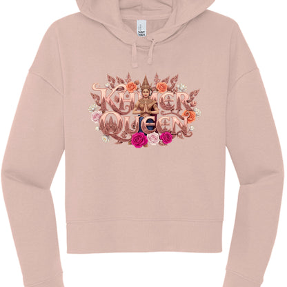 This image features a dusty rose or blush-colored cropped hoodie showcasing a highly detailed, ornate graphic centered on the chest. The design celebrates Cambodian heritage with a royal and floral theme.

Design Elements
Typography: The words "KHMER QUEEN" are displayed in a bold, metallic rose-gold font with intricate, carved-style detailing. The letter "Q" in "Queen" features a silhouette of the Angkor Wat temple towers within its center.

Central Figure: A woman dressed in traditional Cambodian Apsara a