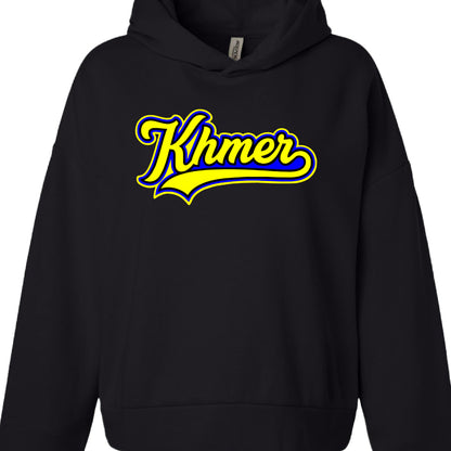 Garment: A black hoodie with dropped shoulders and a front kangaroo pocket.

Text: The word "Khmer" is written in a stylized, cursive script.

Typography Style: Both utilize a baseball or varsity-style aesthetic, featuring thick outlines and a "swoosh" tail extending from the final letter.

Brand: A white "INDEPENDENT" brand tag is visible inside the neckline of both garments.