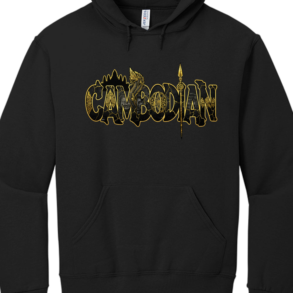 The graphic is composed of gold outlines and intricate textures set against the black fabric, integrating several cultural symbols:

Background Silhouette: Above the text, the distinctive towers of Angkor Wat are visible in a gold outline.

The Naga (Serpent): A golden Naga head rises between the letters "M" and "B," a central figure in Khmer mythology representing protection and water.

Serene Faces: Faint, stone-textured faces—likely representing the Bayon style found at Angkor Thom—are visible within the