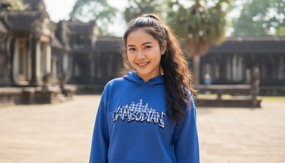 Person wearing a blue hoodie with text in an outdoor setting