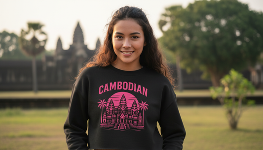 Person wearing a black sweatshirt with 'Cambodian' and temple design outdoors.