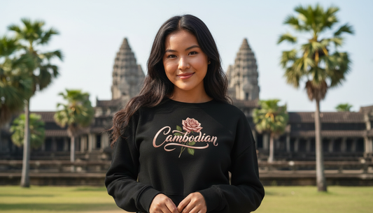 Woman wearing a black sweatshirt with 'Cambodian' text in front of Angkor Wat.
