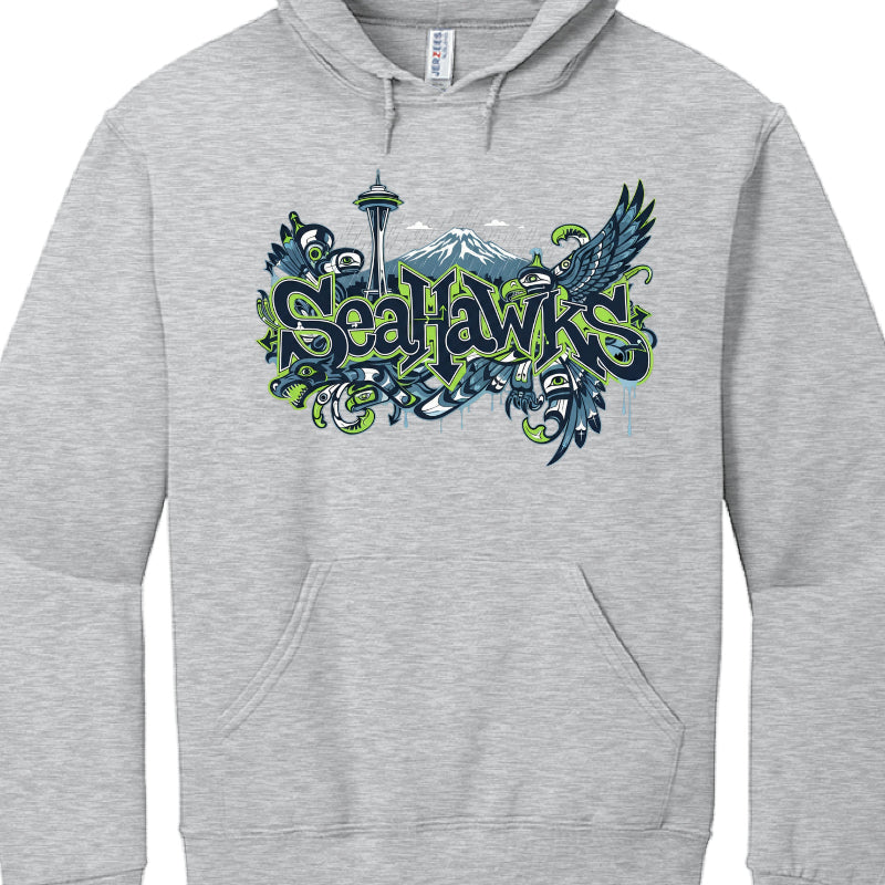 Gray hoodie with 'Seahawks' logo featuring the Space Needle and mountains on a white background