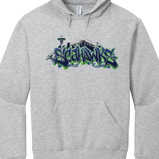 These hoodies celebrate the Seattle Seahawks with stylized graphics incorporating the team's colors and iconic Seattle landmarks.

Northwest Coast Style (image_a4521c.jpg): A black hoodie featuring a central osprey (seahawk) rendered in an indigenous art style. The Space Needle rises behind the bird, and the word "SEAHAWKS" is printed in a bold, green and blue 3D-effect font.

Graffiti Skyline Style (image_a455be.jpg): A heather grey hoodie featuring the word "SEAHAWKS" in a navy and neon green graffiti-sty