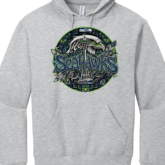 The provided images show two different hoodies featuring stylized graphics for the Seattle Seahawks.

Black Hoodie Graphic (image_a4655b.jpg)
This design uses a sharp, urban aesthetic:

Typography: The word "SEAHAWKS" is rendered in a jagged, 3D graffiti-style font with blue, green, and white outlines.

Skyline: A black silhouette of the Seattle skyline, including the Space Needle and the Great Wheel, sits directly above the text.

Decorative Accents: The design includes several stylized feathers in blue an