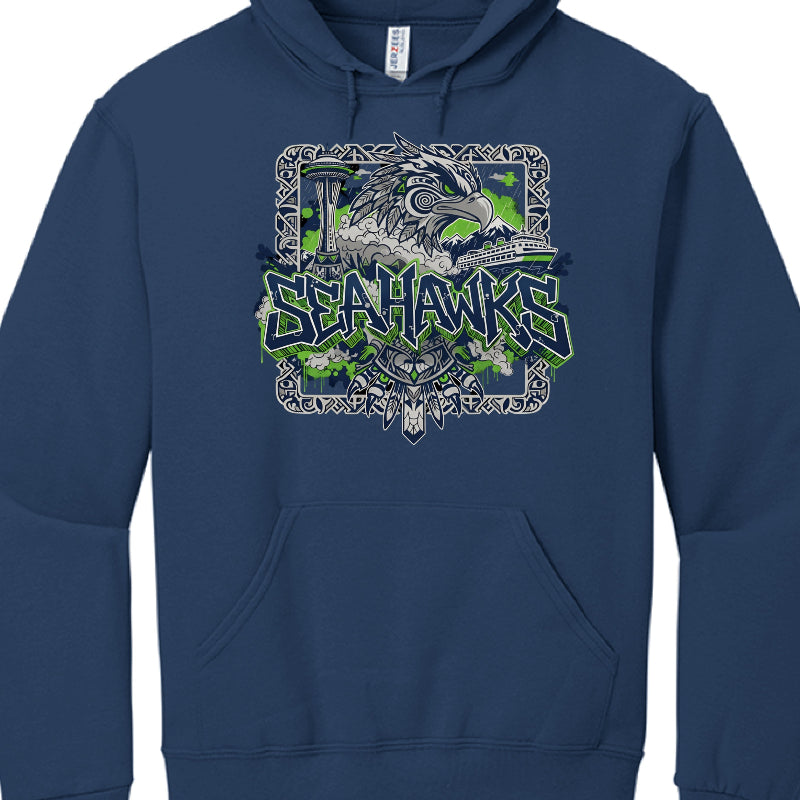 Individual Garment Analysis
Navy Blue Hoodie:

Main Graphic: Features a large, grey illustration of a seahawk rendered in a Pacific Northwest Indigenous (Formline) art style.

Typography: The word "SEAHAWKS" is centered in a sharp, graffiti-style font with neon green outlines.

Details: The background subtly includes a grey silhouette of the Seattle skyline with the Space Needle, as well as clouds with lightning bolts and evergreen trees.

Heather Grey Hoodie:

Central Theme: Focuses on Seattle’s maritime a