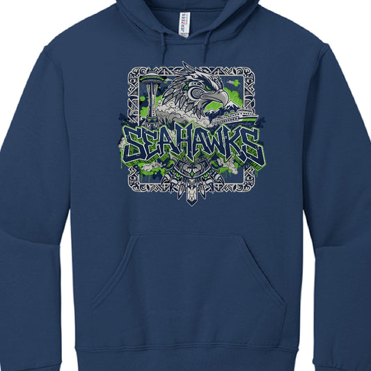 Individual Garment Analysis
Navy Blue Hoodie:

Main Graphic: Features a large, grey illustration of a seahawk rendered in a Pacific Northwest Indigenous (Formline) art style.

Typography: The word "SEAHAWKS" is centered in a sharp, graffiti-style font with neon green outlines.

Details: The background subtly includes a grey silhouette of the Seattle skyline with the Space Needle, as well as clouds with lightning bolts and evergreen trees.

Heather Grey Hoodie:

Central Theme: Focuses on Seattle’s maritime a
