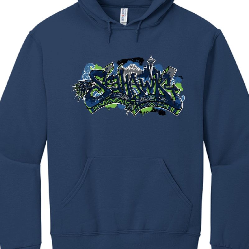 This image features a navy blue hooded sweatshirt with a vibrant, multi-layered graphic design centered on the chest. The design is a tribute to the Seattle Seahawks and the city of Seattle, rendered in a stylized graffiti and Pacific Northwest indigenous art aesthetic.