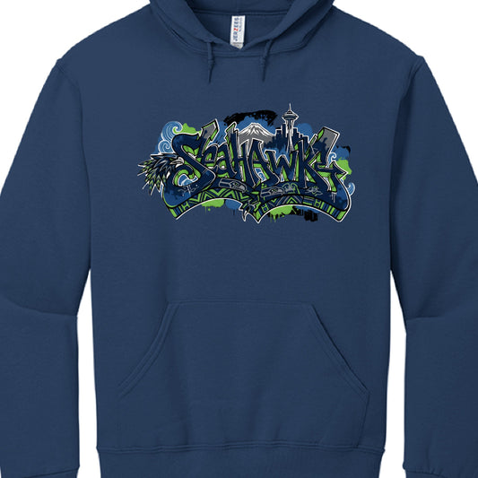 This image features a navy blue hooded sweatshirt with a vibrant, multi-layered graphic design centered on the chest. The design is a tribute to the Seattle Seahawks and the city of Seattle, rendered in a stylized graffiti and Pacific Northwest indigenous art aesthetic.