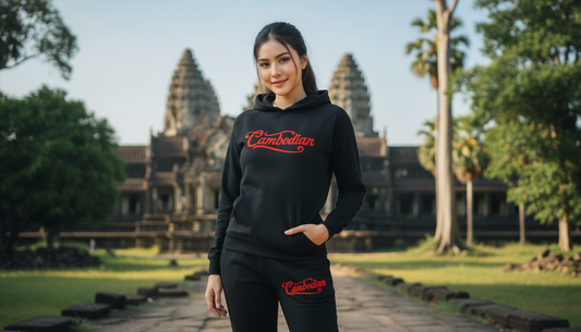 Person wearing a black hoodie with 'Cambodian' text in front of Angkor Wat.